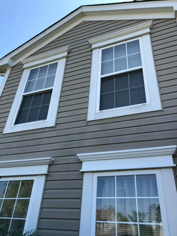 Two-story house exterior with brown siding, white trim, and four rectangular windows, two on each floor. - My Personal Painter - My Personal Painter Two-story house exterior with brown siding, white trim, and four rectangular windows, two on each floor.