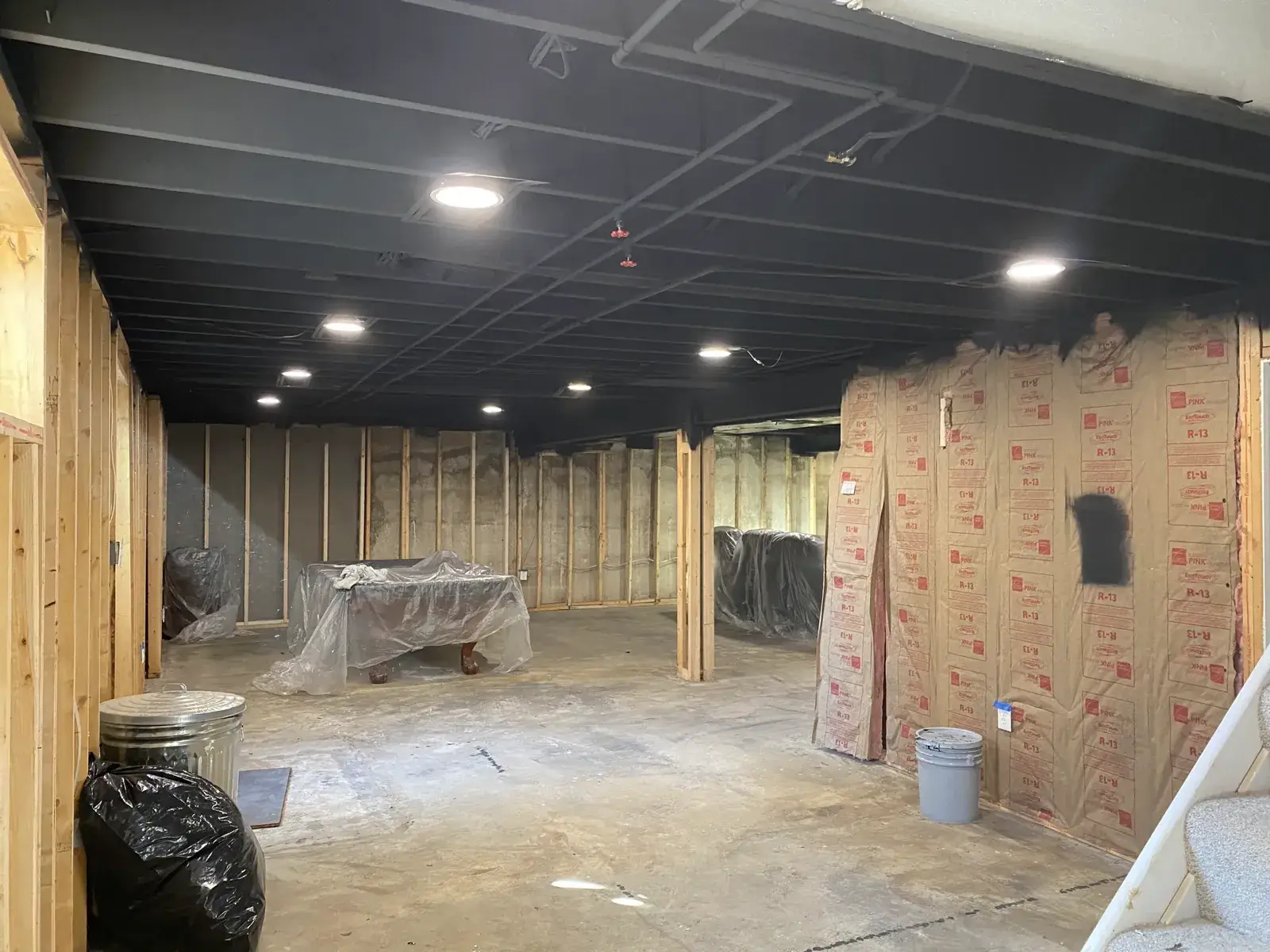 After: basement ceiling joists sprayed black
