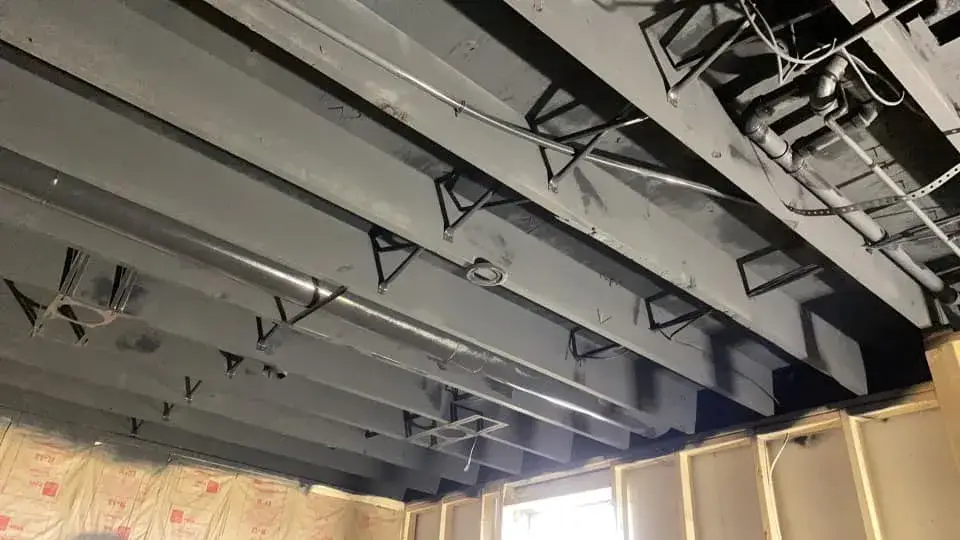 After: basement ceiling joists sprayed black