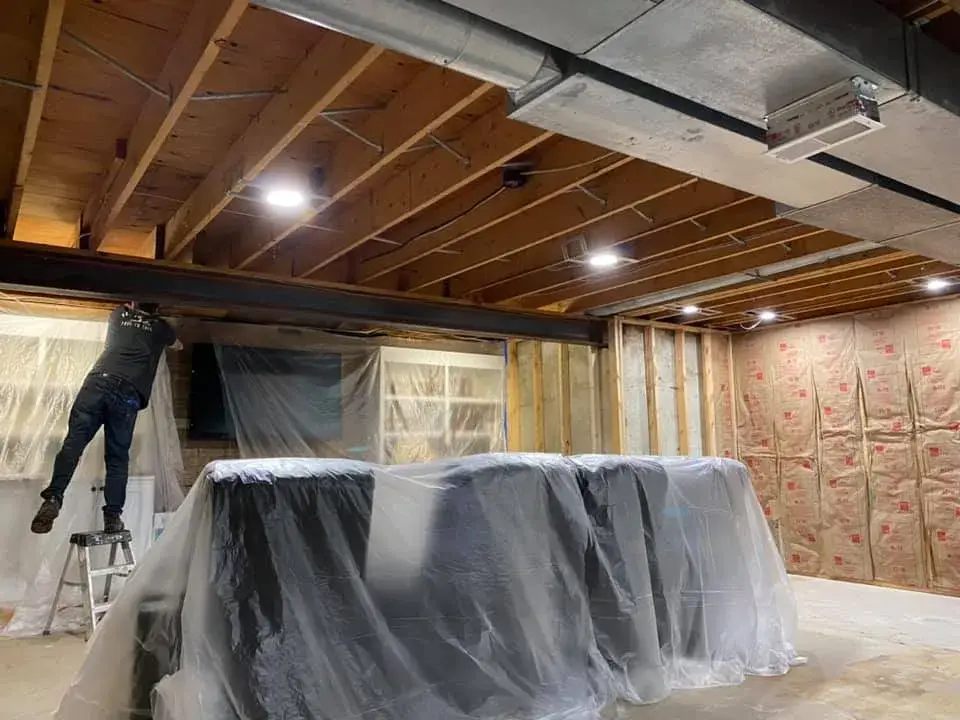 In progress: basement ceiling joists sprayed black