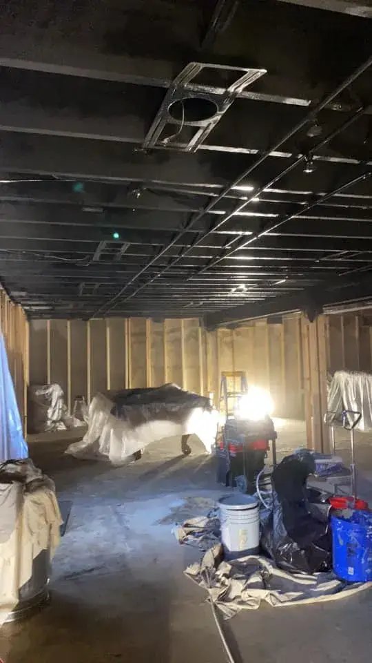 In progress: basement ceiling joists sprayed black