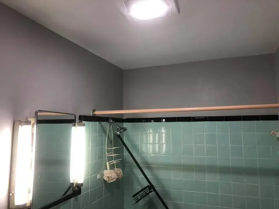 After: bathroom with teal tile: peeling walls repaired and repainted