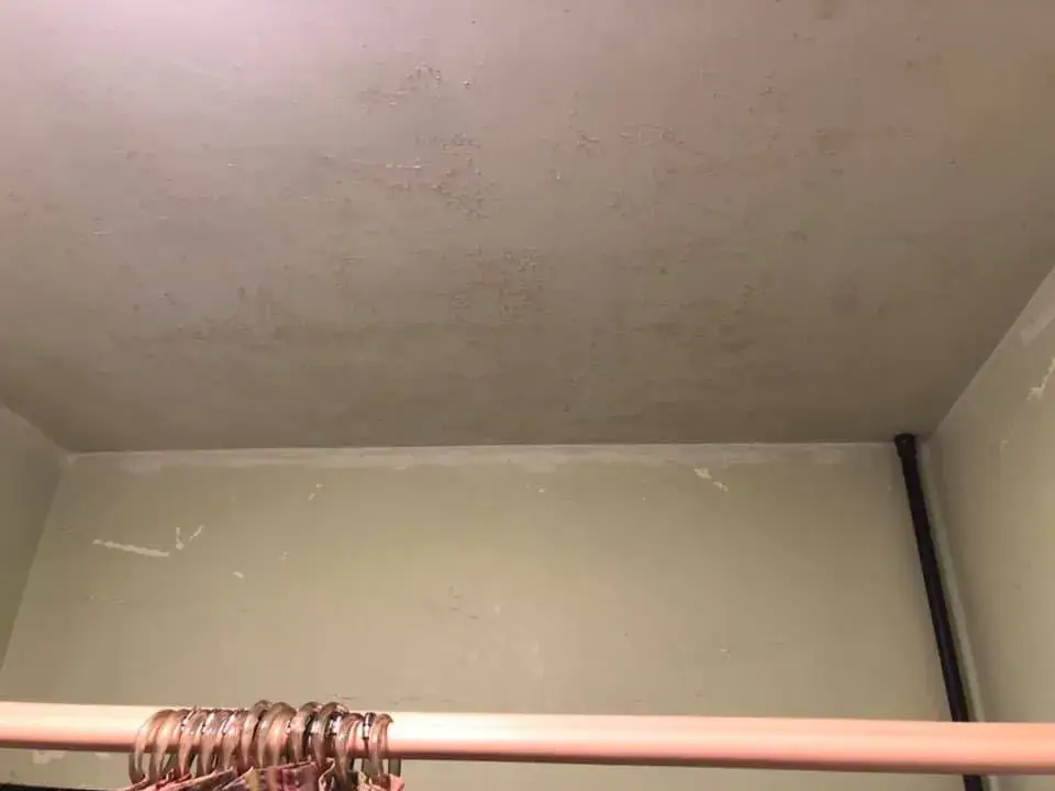 Before: bathroom with teal tile: peeling walls repaired and repainted