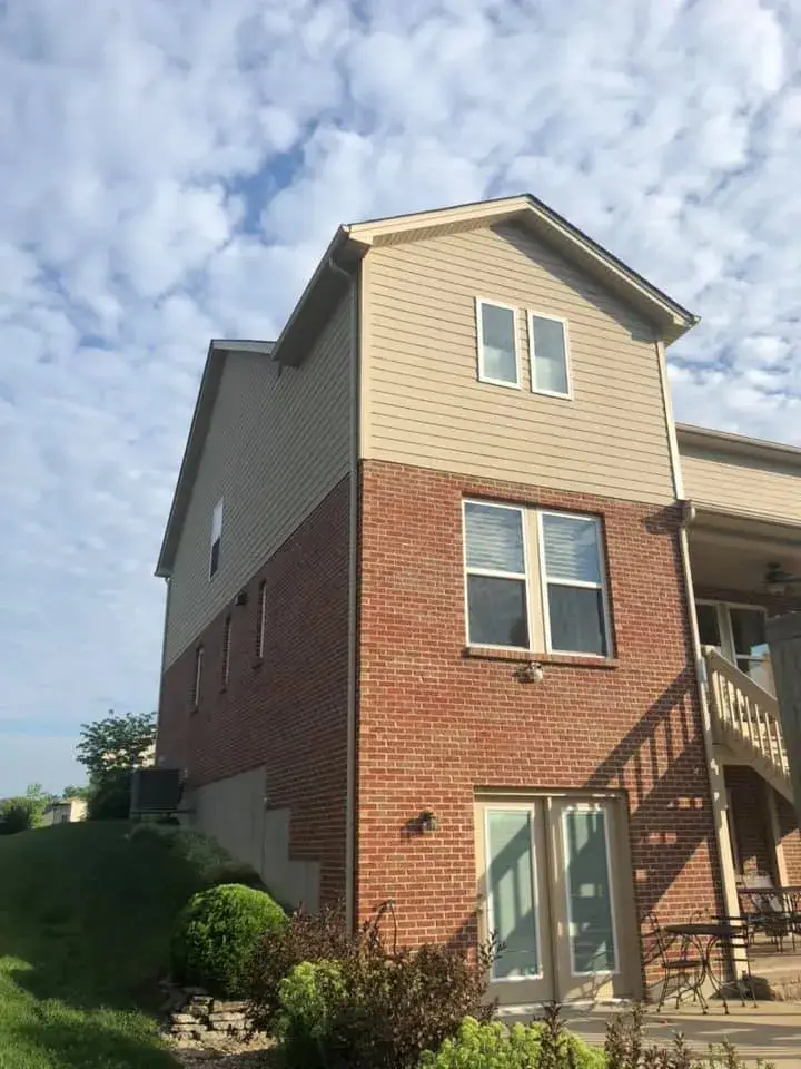 After: brick and tan siding house exterior painted