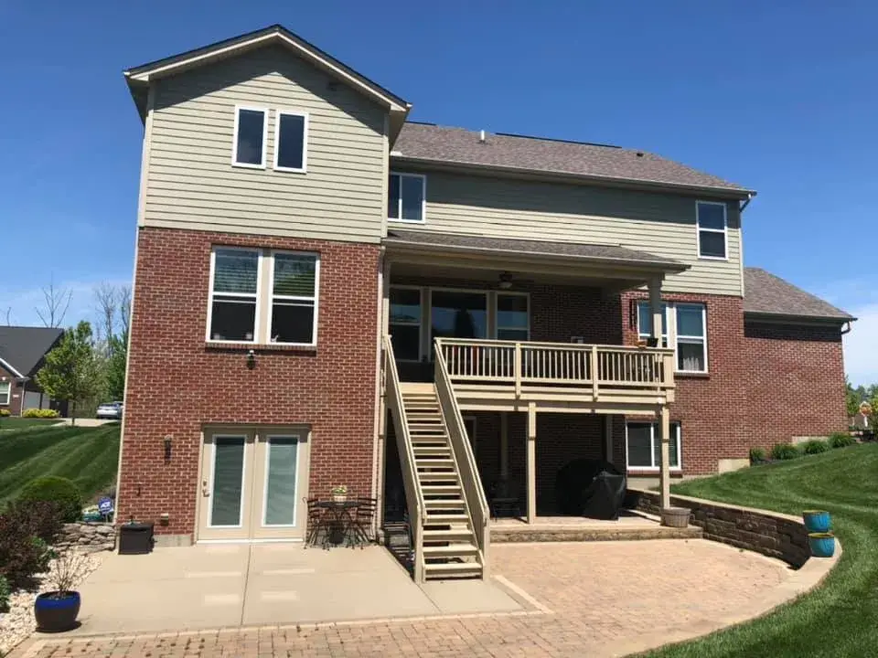 After: brick and tan siding house exterior painted