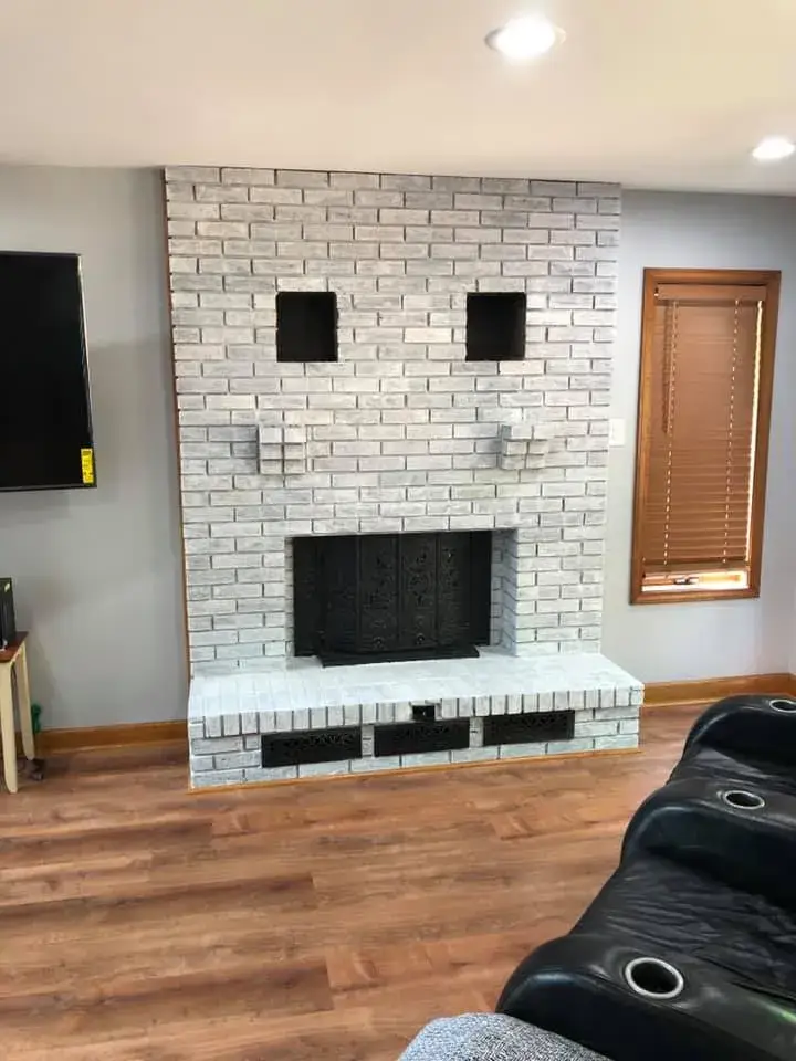 After: brick fireplace with two niches painted white
