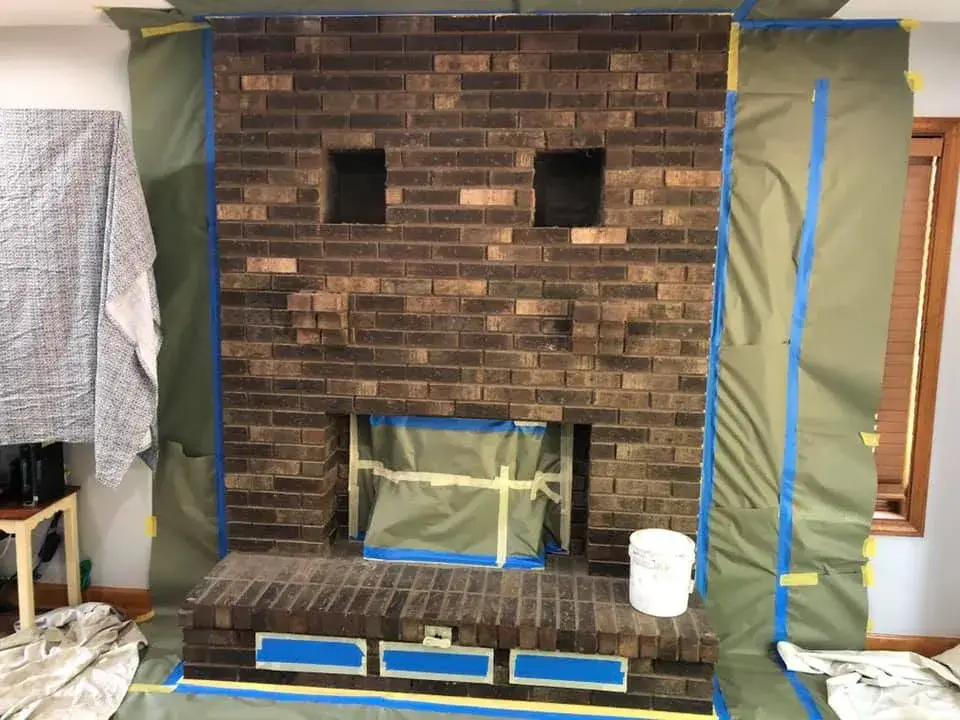 Before: brick fireplace with two niches painted white