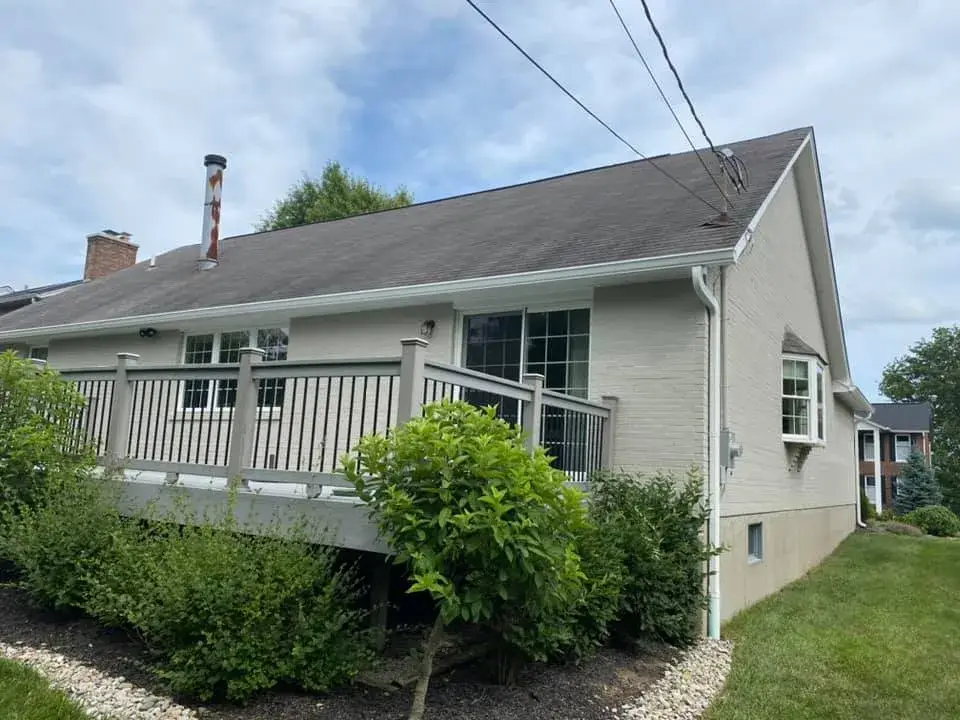 After: brick ranch exterior painted light gray