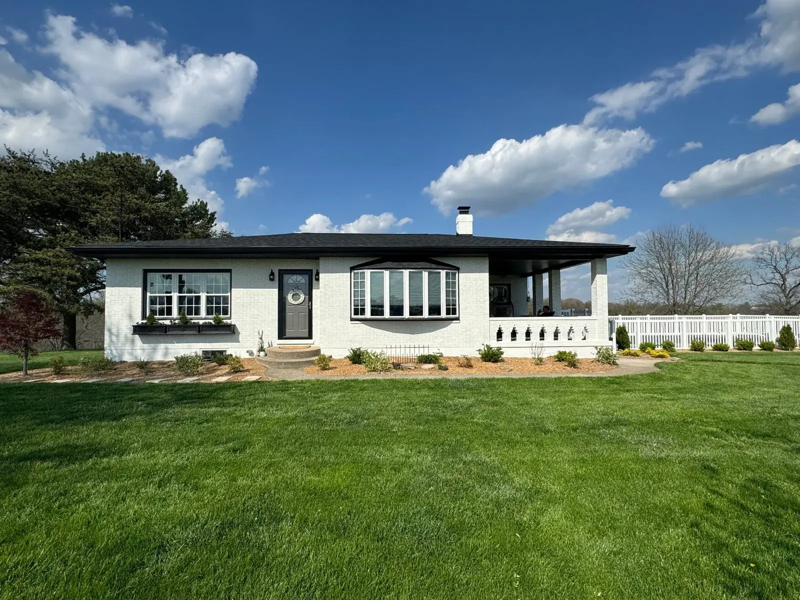 After: brick ranch painted white