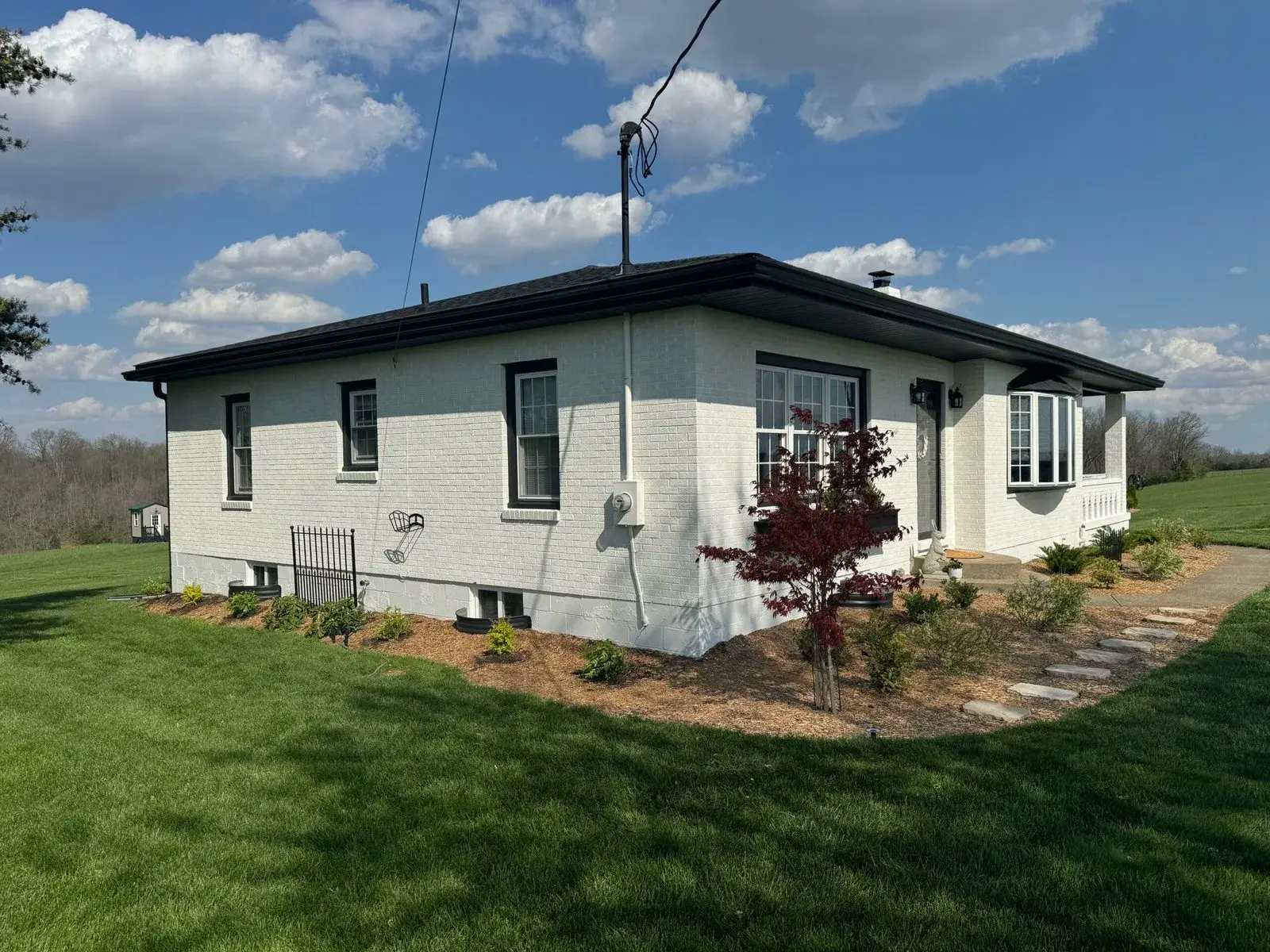 After: brick ranch painted white