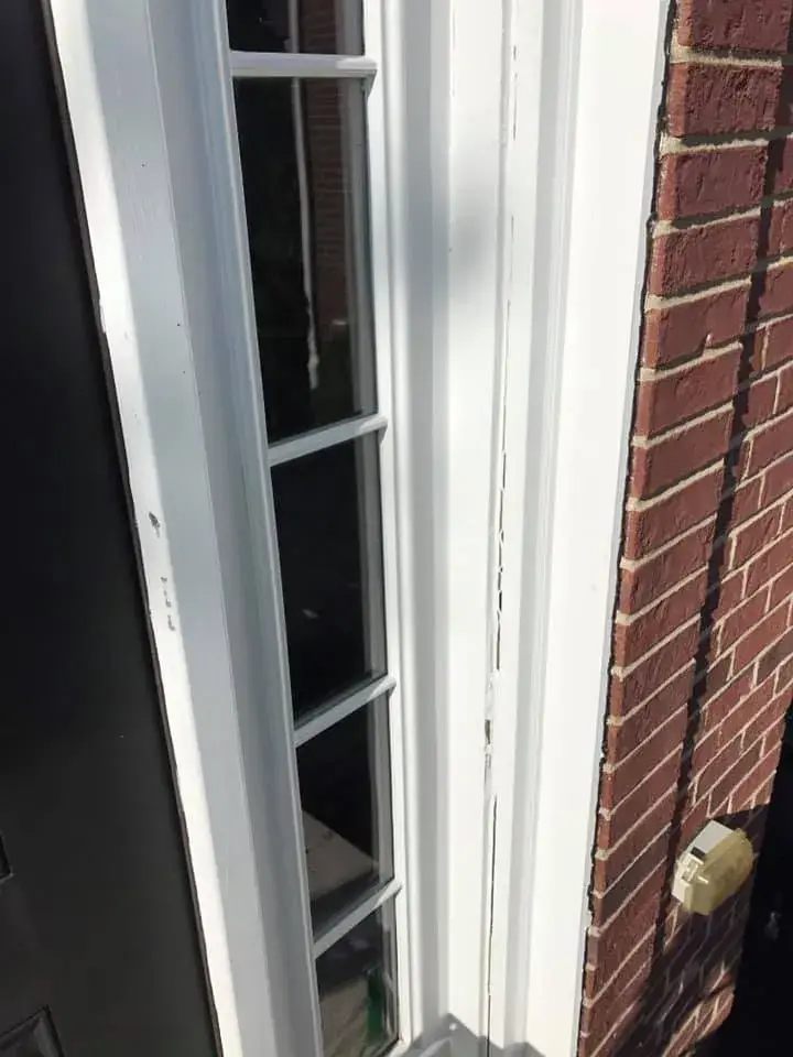 After: brick two-story front entry: rotted trim repaired, trim painted white, red door painted black