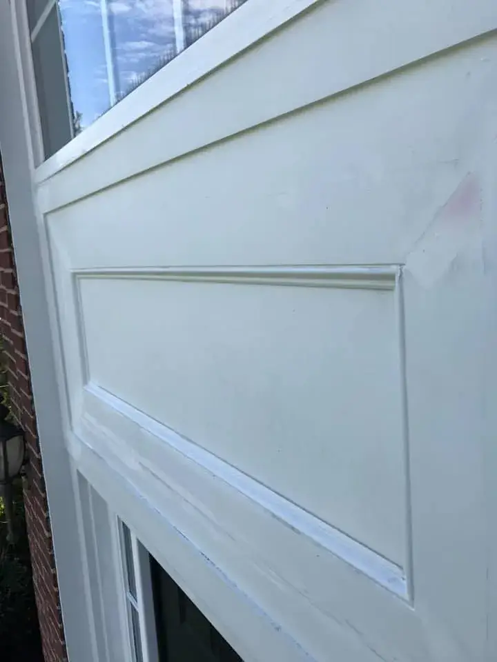 After: brick two-story front entry: rotted trim repaired, trim painted white, red door painted black