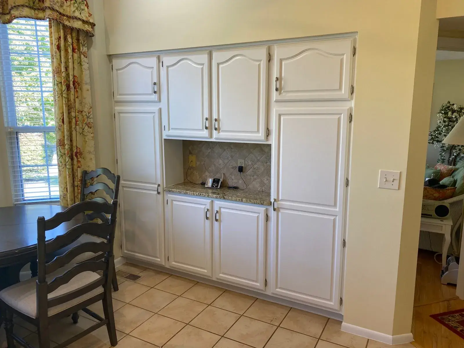 After: built-in kitchen cabinets: wood painted white