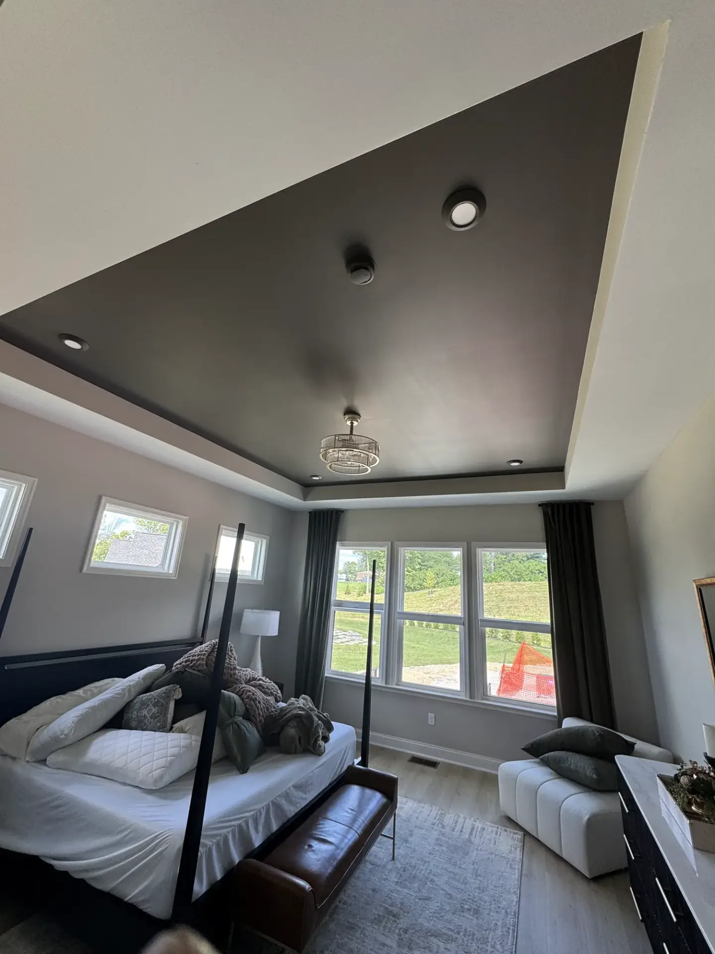 Bedroom with a charcoal painted tray ceiling and light gray walls
