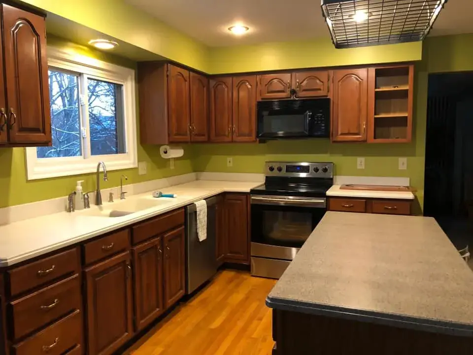 Before: cherry kitchen painted white uppers, gray-blue island and lowers