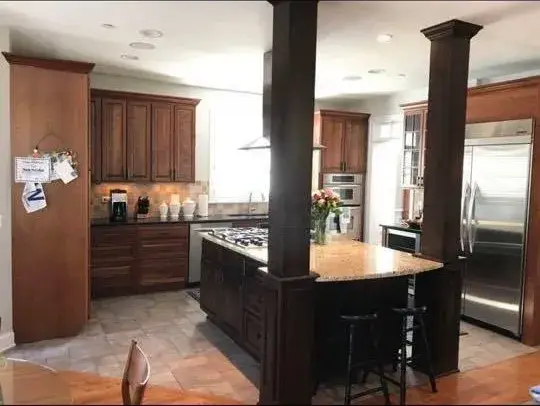 Before: cherry kitchen with column painted white, gray island