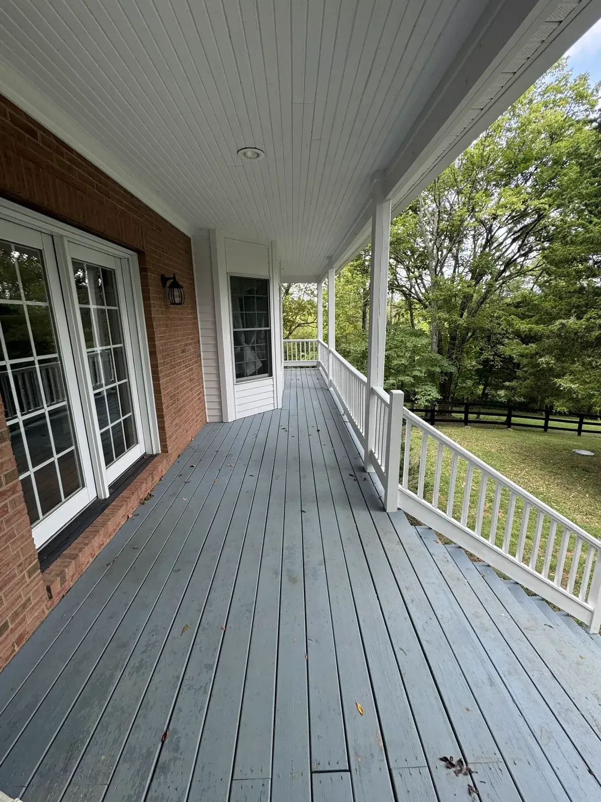 Before: covered porch floor painted (August 2024)