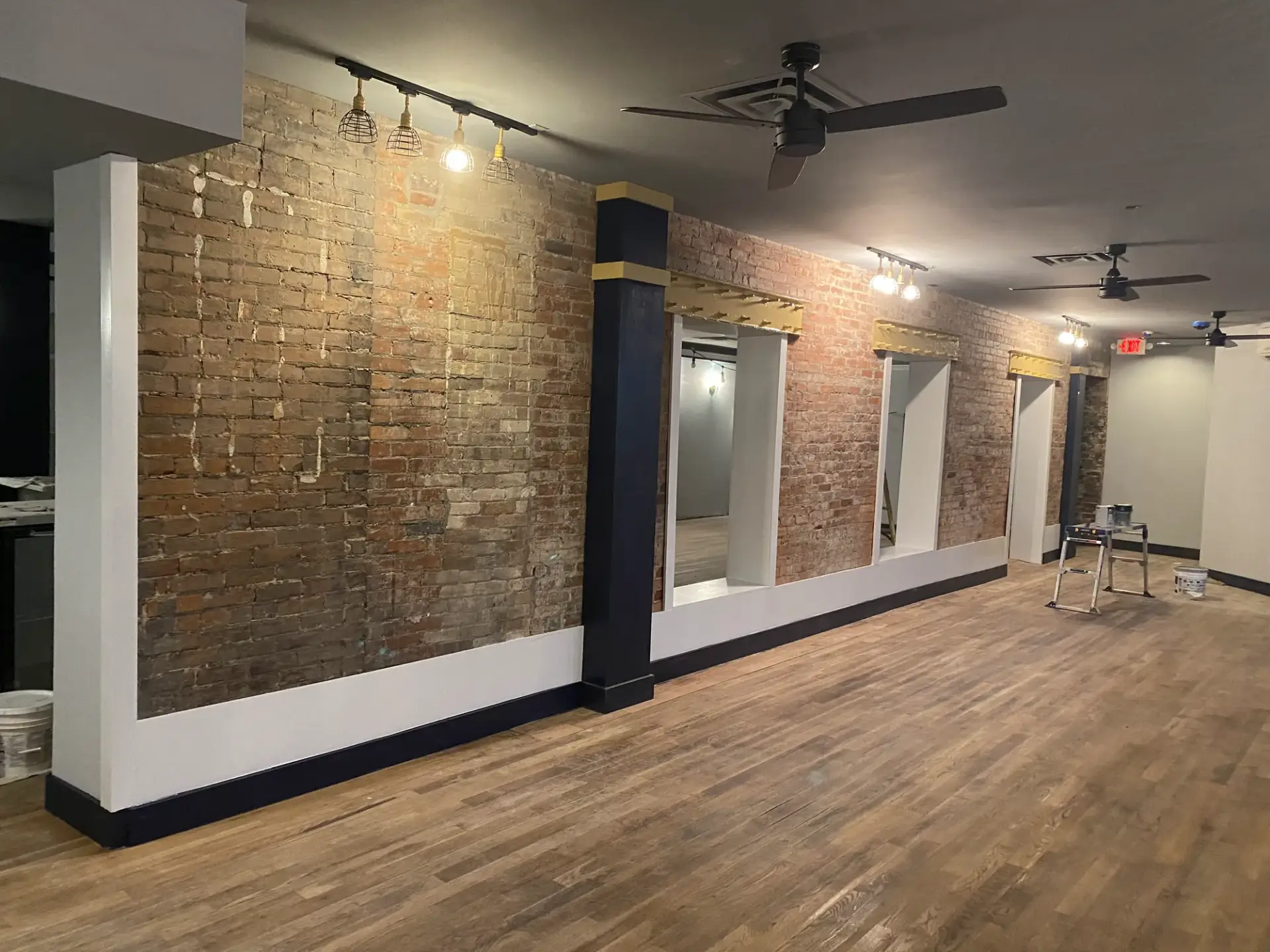 Commercial space with exposed red brick before whitewashing