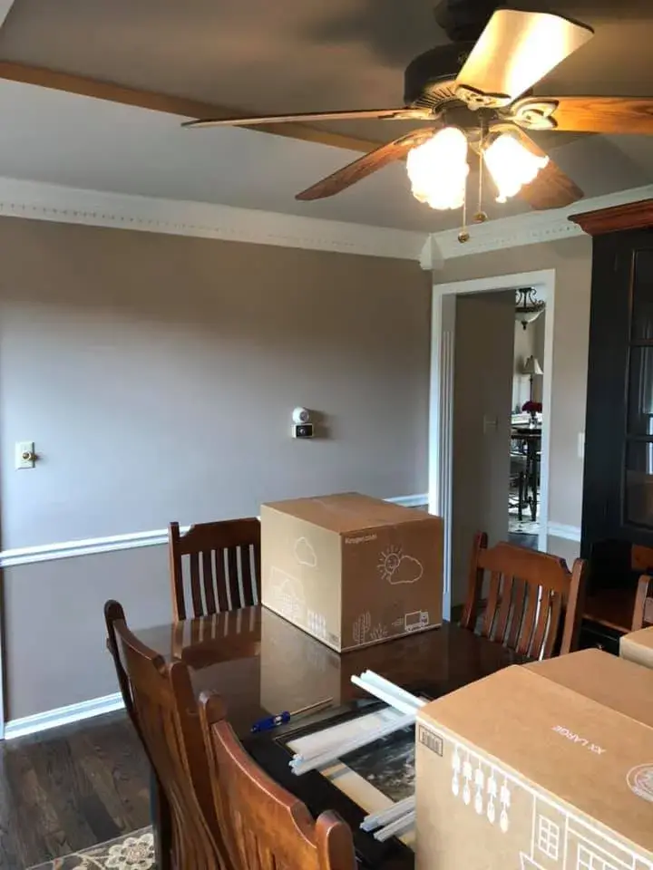 After: foyer, pool table room and dining room: wood trim painted white