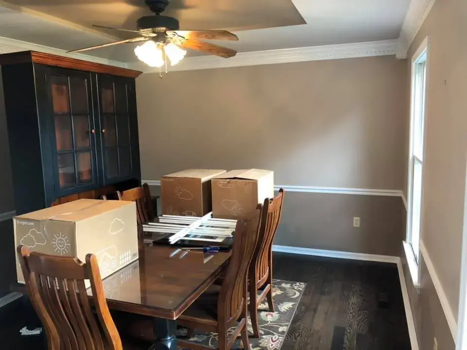 After: foyer, pool table room and dining room: wood trim painted white