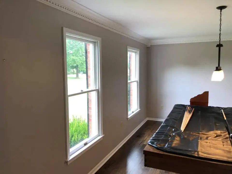 After: foyer, pool table room and dining room: wood trim painted white
