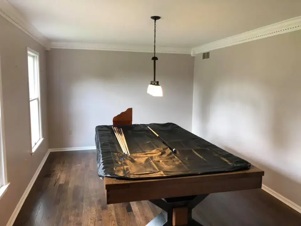 After: foyer, pool table room and dining room: wood trim painted white