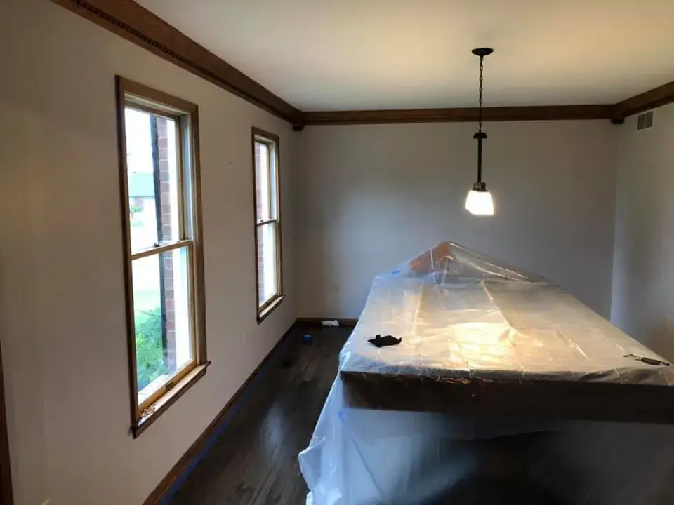 Before: foyer, pool table room and dining room: wood trim painted white