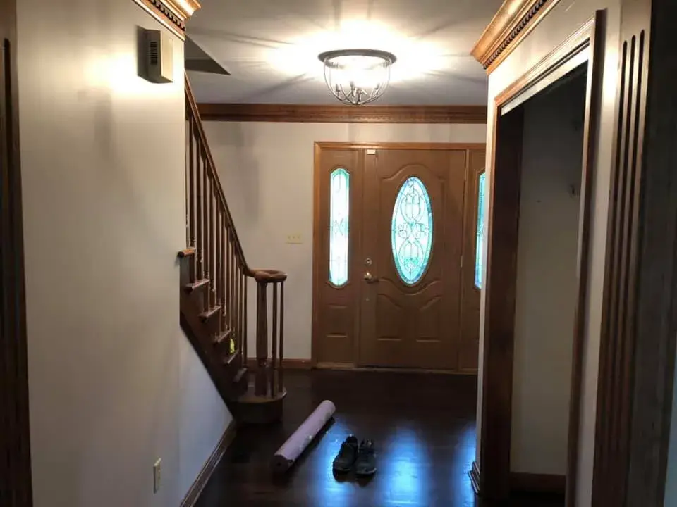 Before: foyer, pool table room and dining room: wood trim painted white