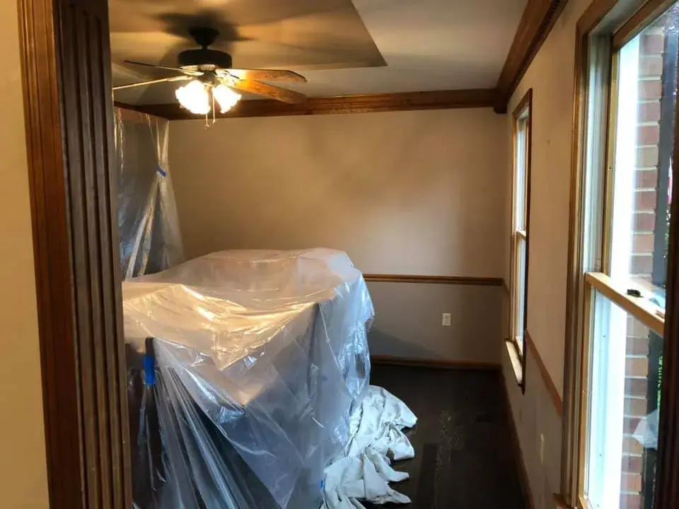 Before: foyer, pool table room and dining room: wood trim painted white