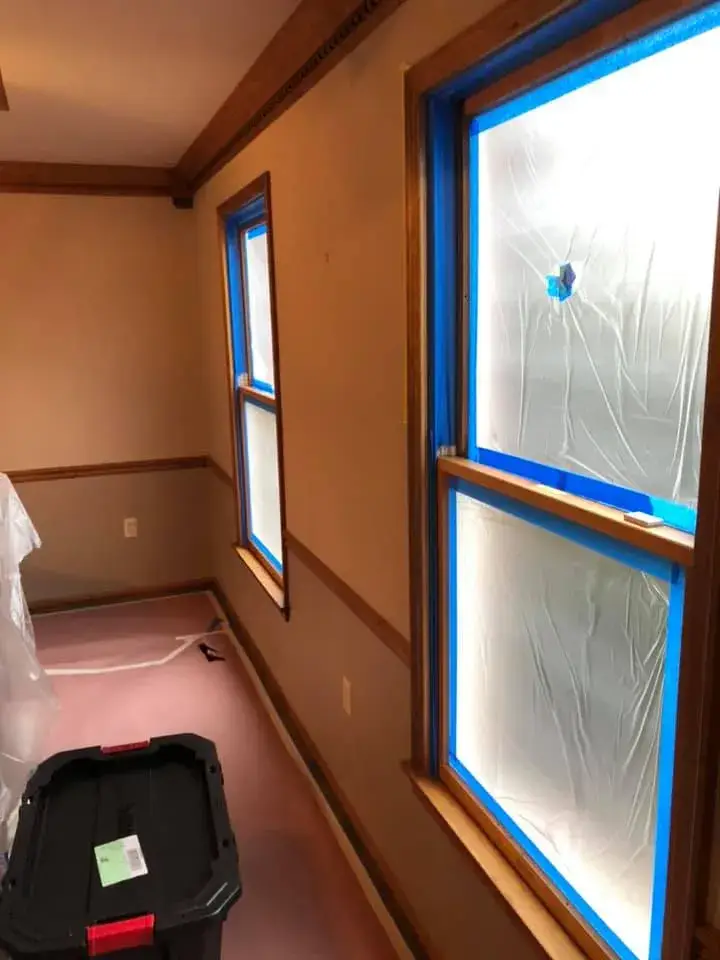 In progress: foyer, pool table room and dining room: wood trim painted white