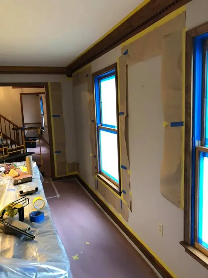 In progress: foyer, pool table room and dining room: wood trim painted white