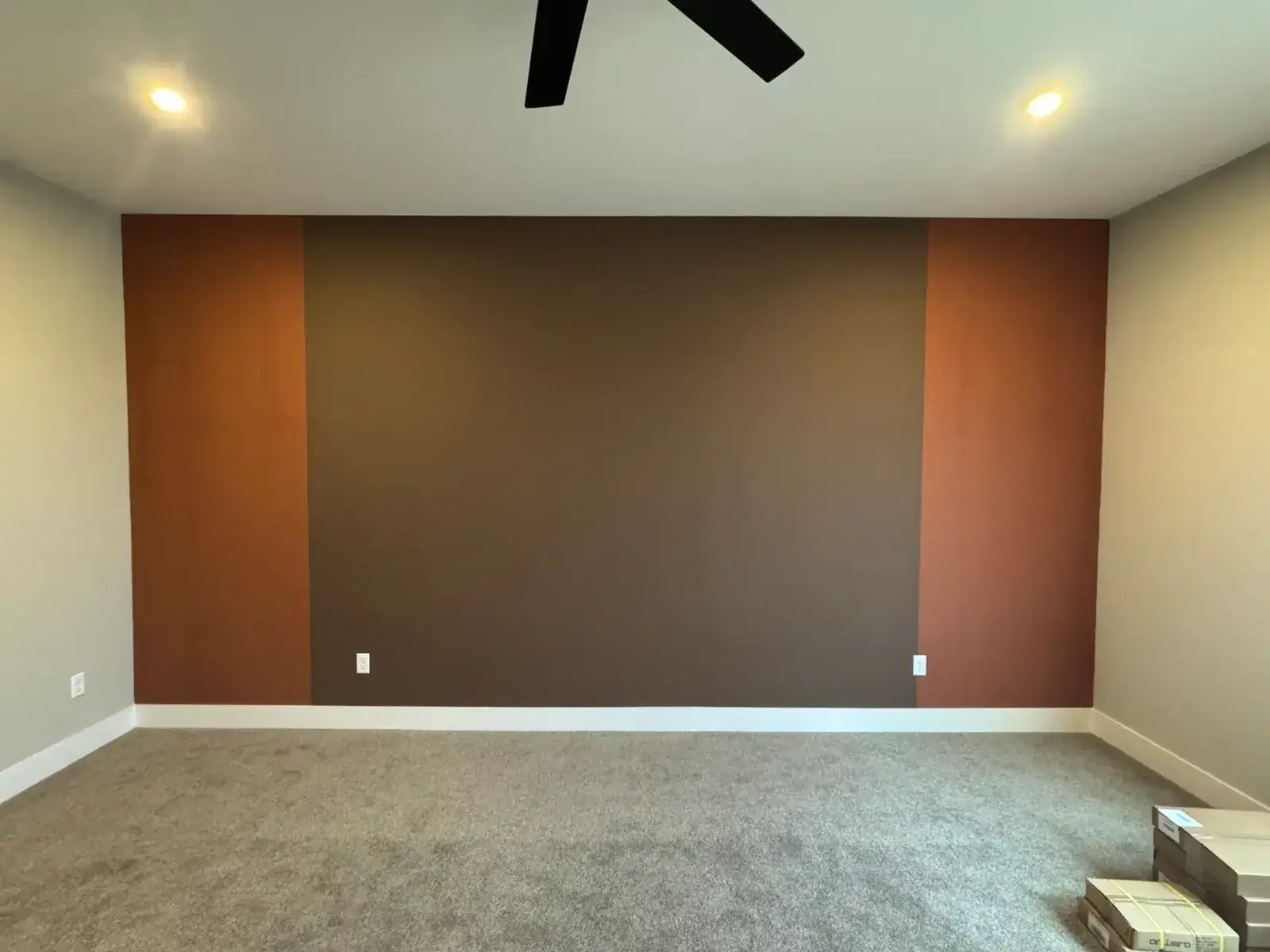 After: green walls beside a tall stone fireplace, brown and copper bedroom accent wall