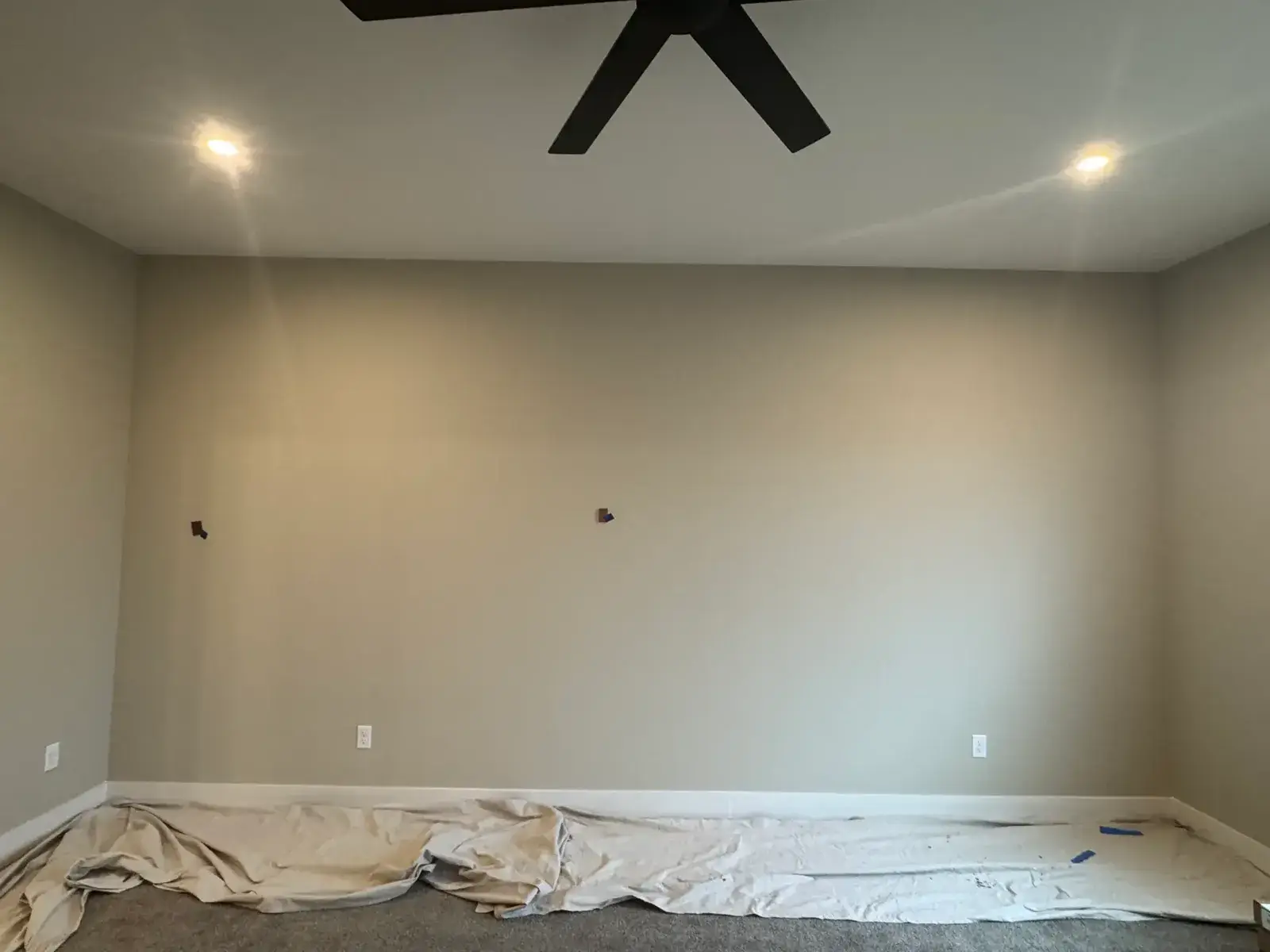 Before: green walls beside a tall stone fireplace, brown and copper bedroom accent wall