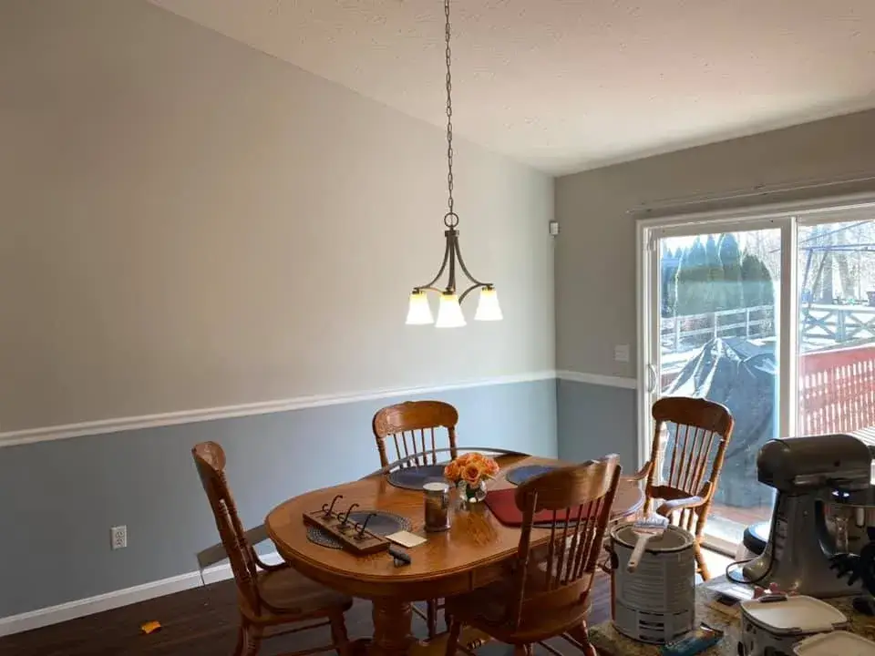After: interior repaint: red and orange lower walls to gray, chair rail