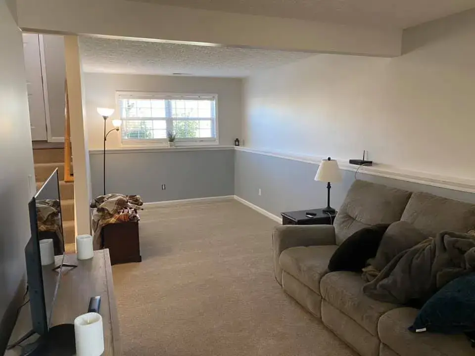 After: interior repaint: red and orange lower walls to gray, chair rail