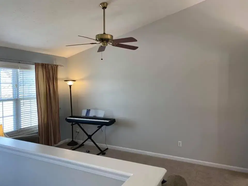 After: interior repaint: red and orange lower walls to gray, chair rail