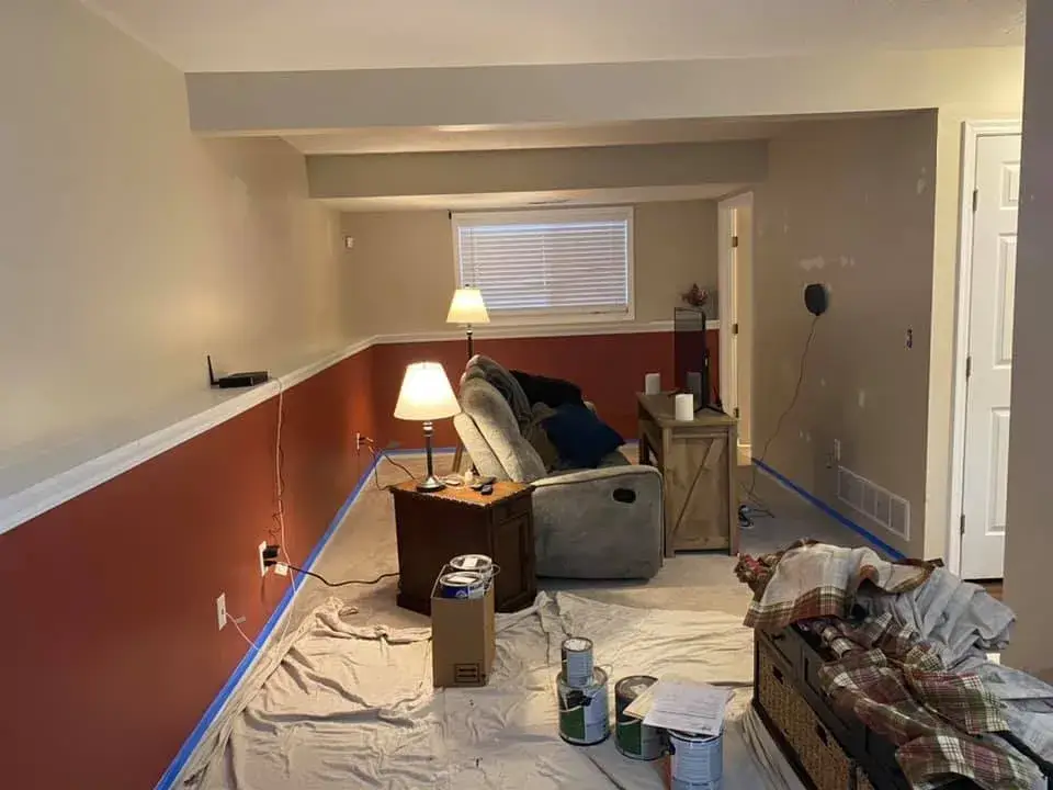 Before: interior repaint: red and orange lower walls to gray, chair rail