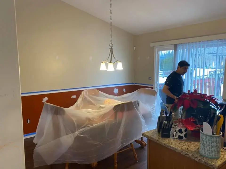 Before: interior repaint: red and orange lower walls to gray, chair rail