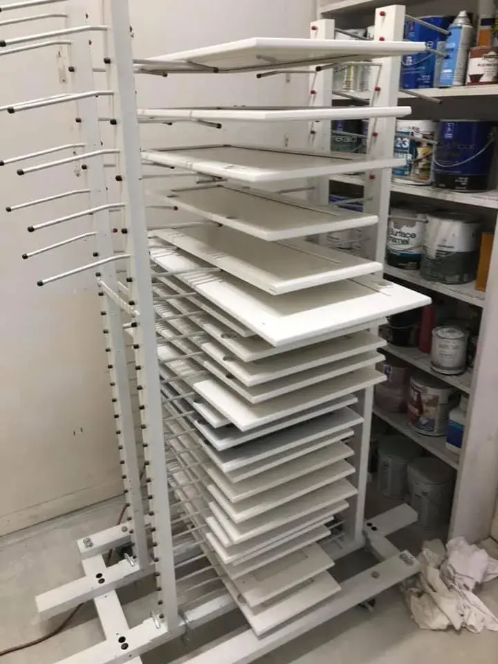 In progress: kitchen cabinets glazed and painted white with a granite island