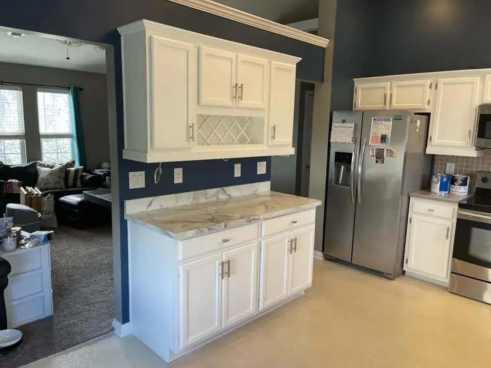 Before: kitchen cabinets painted black under navy walls