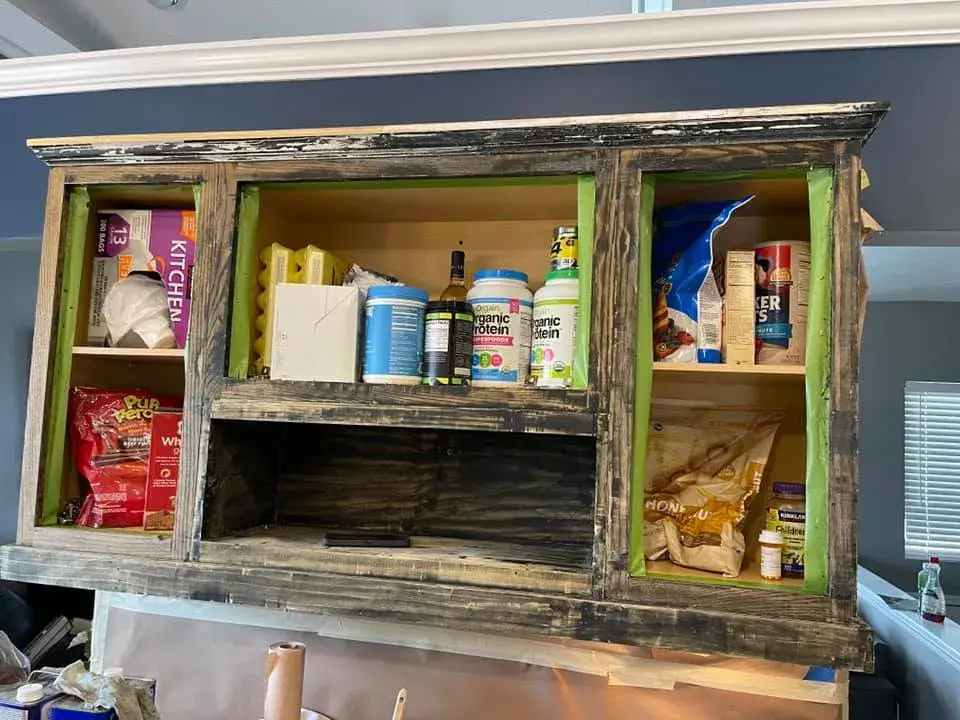 In progress: kitchen cabinets painted black under navy walls