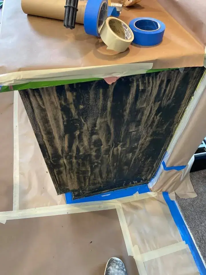In progress: kitchen cabinets painted black under navy walls