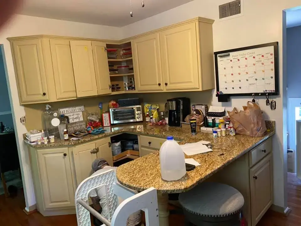 Before: kitchen cabinets painted white, granite counters