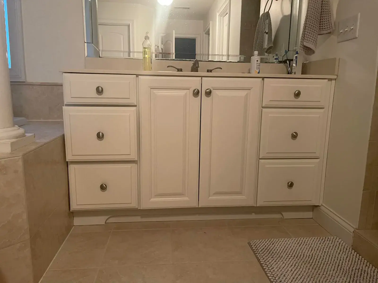 White bathroom vanity with two cabinets and six drawers, topped by a mirror. - My Personal Painter - My Personal Painter After: kitchen cherry cabinets to white with a green island, two-story great room, dining room and foyer