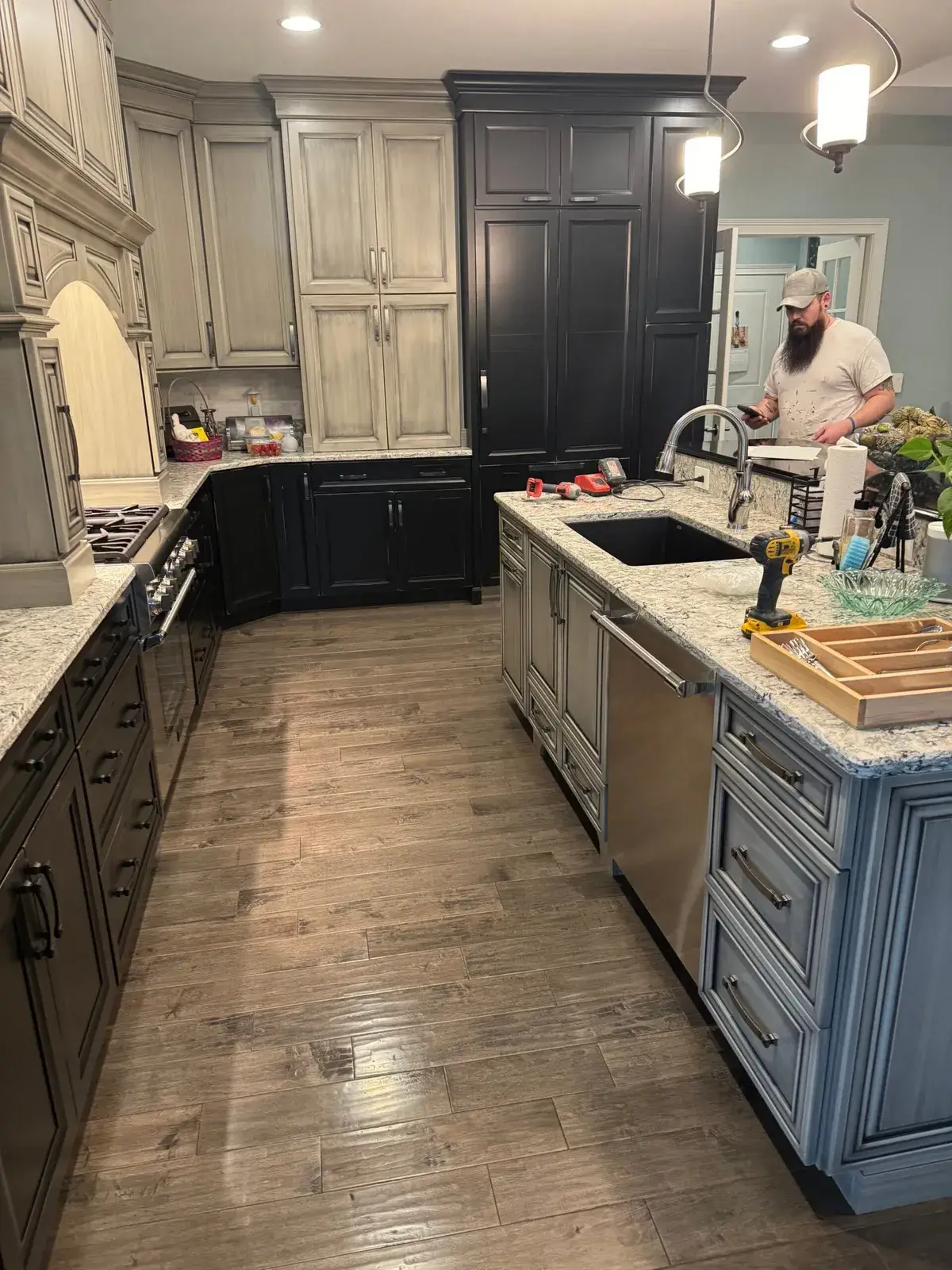 Before: kitchen glazed sage cabinets painted white, dark lowers and pendant lights