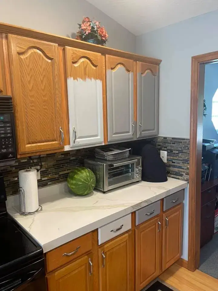 Kitchen cabinets in the process of being painted from wood finish to gray. - My Personal Painter - My Personal Painter In progress: kitchen oak cabinets painted gray, vaulted ceiling with beam