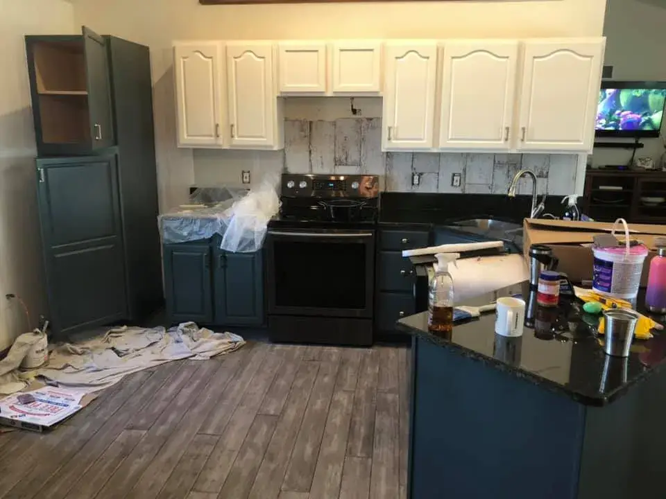 After: kitchen oak cabinets painted white uppers with dark green lowers