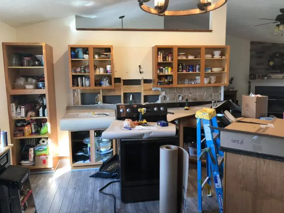 In progress: kitchen oak cabinets painted white uppers with dark green lowers