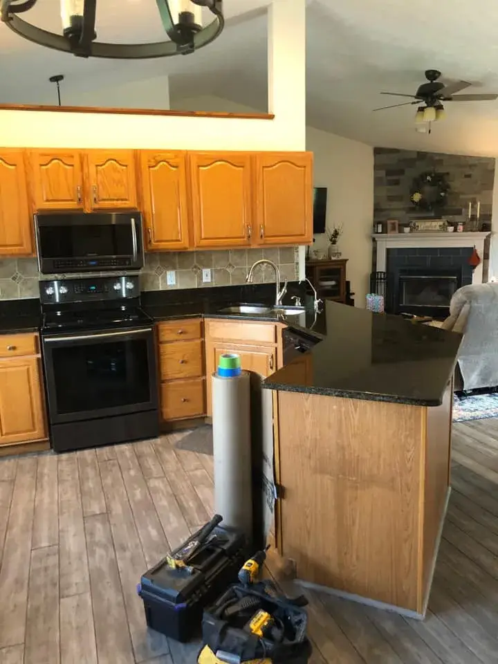 In progress: kitchen oak cabinets painted white uppers with dark green lowers