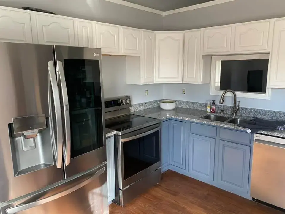 After: kitchen oak cabinets to white uppers and blue-gray lowers
